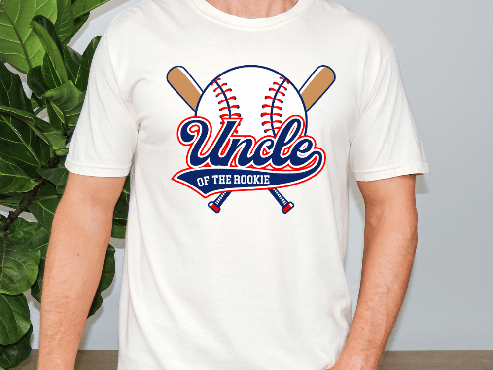 A white t-shirt with a graphic design featuring a baseball bat and a baseball, along with the text "Uncle of the Rookie".
