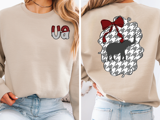 The image is a collage of two photos. In the left photo, a woman is wearing a beige sweater with a red and white pattern on the front and the letters 'VA' on the left side. In the right photo, the woman is wearing a beige sweater with a red and white pattern on the back and a black elephant silhouette.