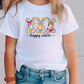 a little girl wearing a happy easter bunny t - shirt