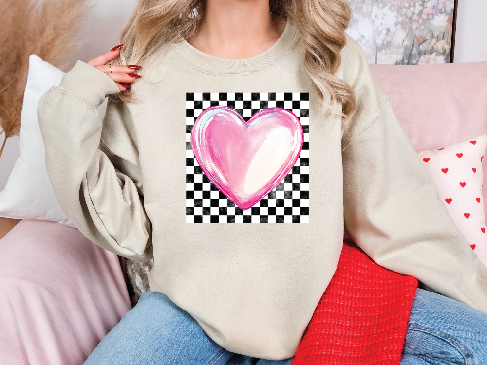 a woman sitting on a couch wearing a sweater with a heart on it