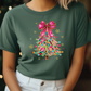 a woman wearing a green t - shirt with a colorful christmas tree on it