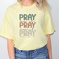 a woman wearing a yellow pray pray t - shirt