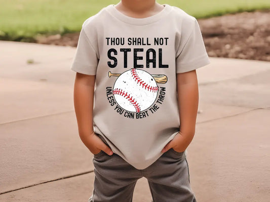 a young boy wearing a t - shirt that says thou shall not steal