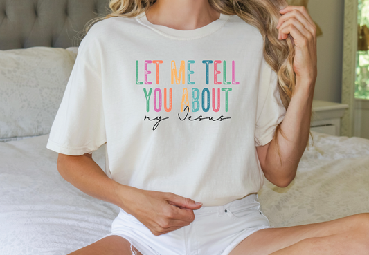 a woman sitting on a bed wearing a t - shirt that says let me tell
