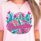 a woman with long hair wearing a pink shirt