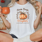 a woman sitting on a bed holding a pumpkin