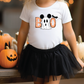 a little girl wearing a mickey mouse shirt