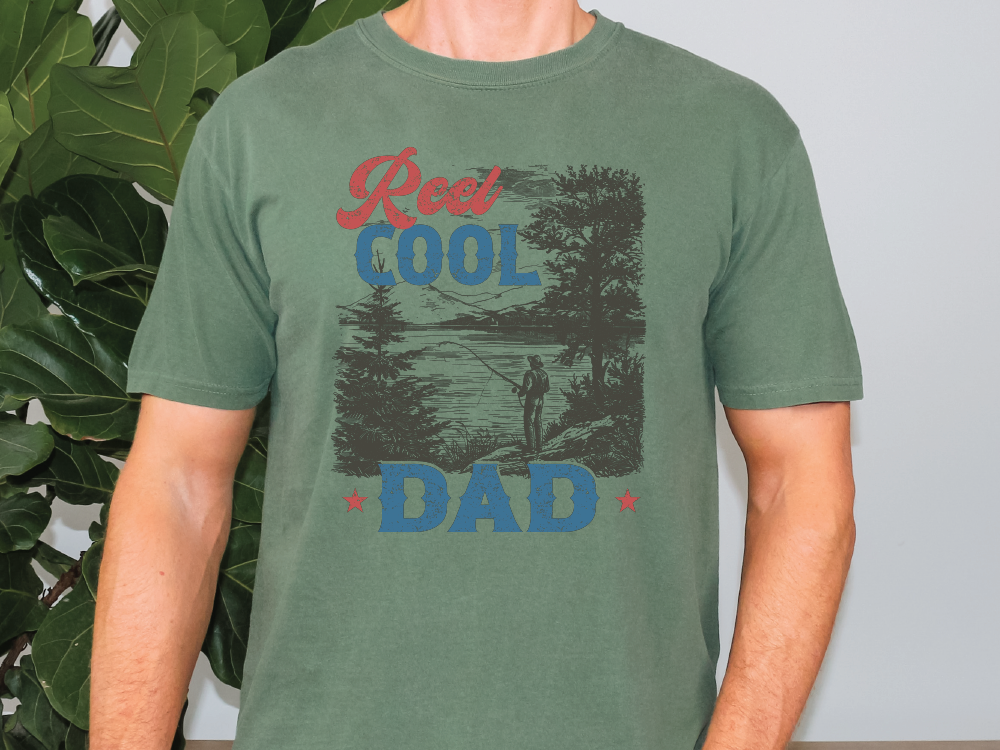 a man standing in front of a plant wearing a green shirt