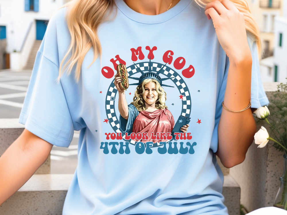a woman wearing a blue t - shirt with a picture of a woman holding a