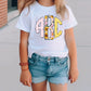 a little girl wearing a white shirt and denim shorts