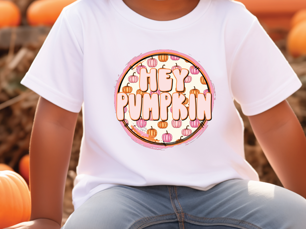 a young boy sitting on a pumpkin patch wearing a happy pumpkin t - shirt