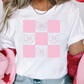 a woman wearing a t - shirt with hearts on it