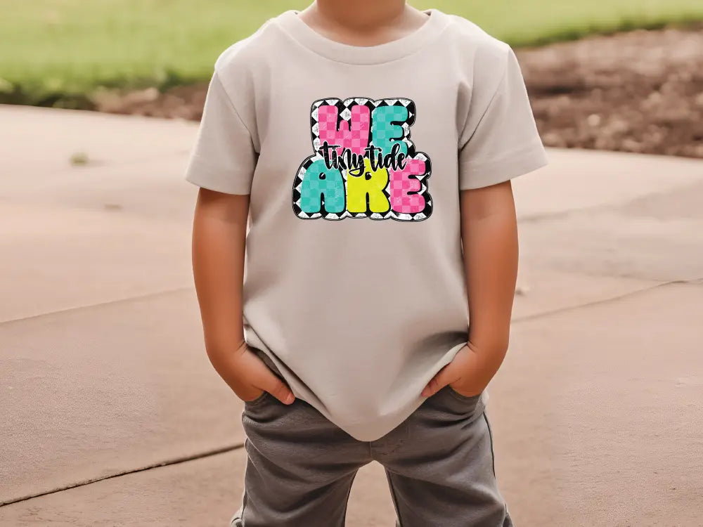 a young boy wearing a t - shirt that says be kind of kind of girl