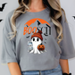 a woman wearing a booch halloween t - shirt