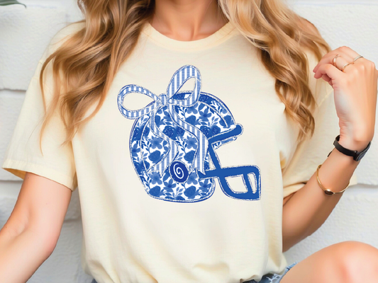 A woman wearing a white t-shirt with a blue and white floral design on it.