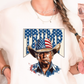 a woman wearing a trump t - shirt holding a brush