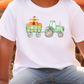 a young boy sitting on a pumpkin patch