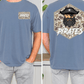 a man wearing a blue t-shirt with a pirate-themed design on the back. The design features a pirate's face with a beard and a black hat, along with the word "PIRATES" written below the image.