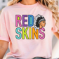 A woman wearing a pink t-shirt with the text "RED SKINS" printed on it.