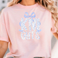 A woman wearing a pink t-shirt with the text "KNIGHTS" printed on it.