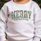 a young child wearing a white sweatshirt with a merry christmas message on it