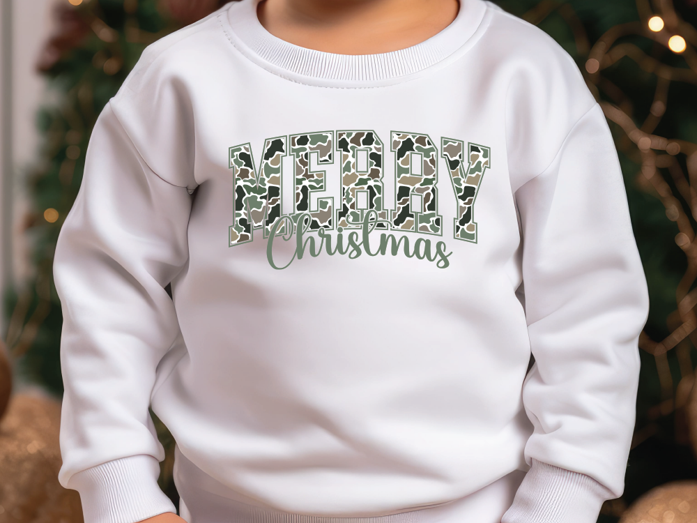 a young child wearing a white sweatshirt with a merry christmas message on it