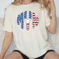 a woman sitting on a couch wearing a t - shirt with an american flag design