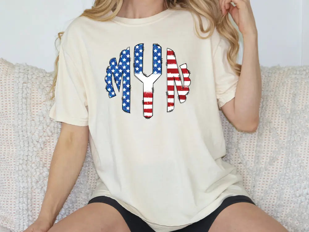 a woman sitting on a couch wearing a t - shirt with an american flag design