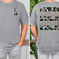 a man wearing a gray t-shirt with a camouflage pattern and the word "EAGLES" printed on the back.