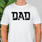 a man wearing a white shirt with the word dad printed on it