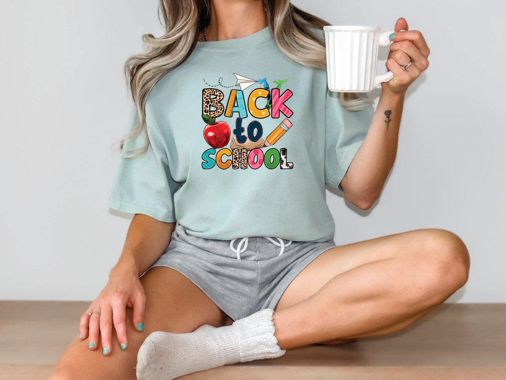 a woman sitting on the floor holding a cup of coffee