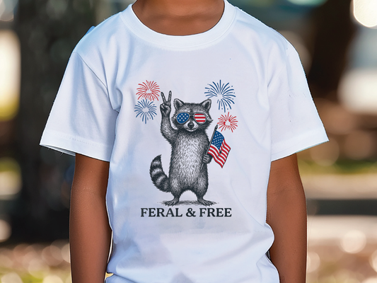 a young boy wearing a white shirt with a raccoon and fireworks on it
