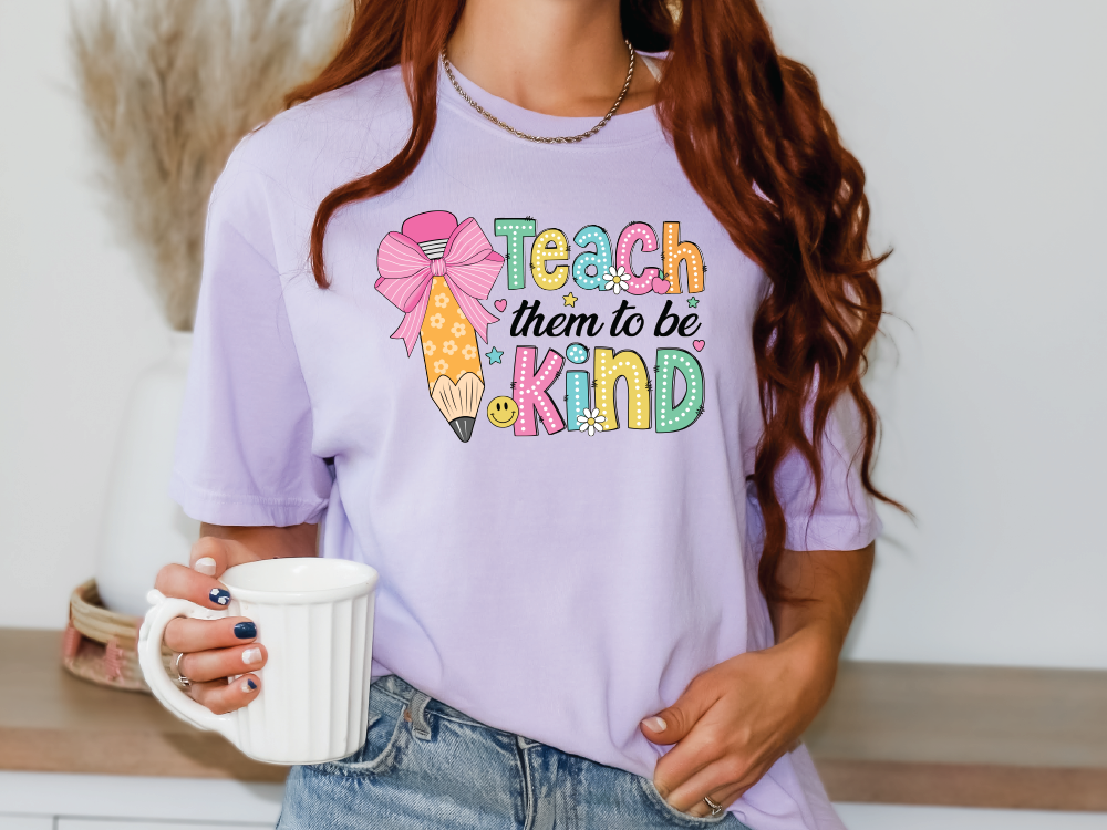 a woman holding a coffee cup and wearing a t - shirt that says teach them