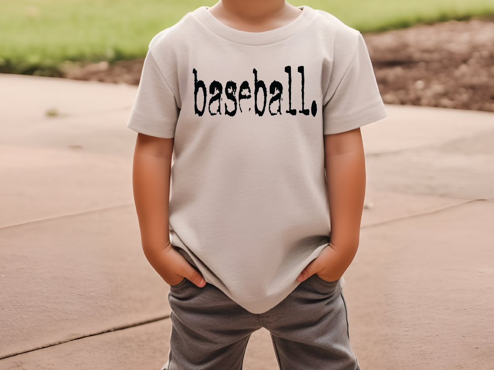 a young boy wearing a baseball t - shirt with the word baseball on it