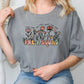 a woman sitting on a chair wearing a grey t - shirt that says pre k