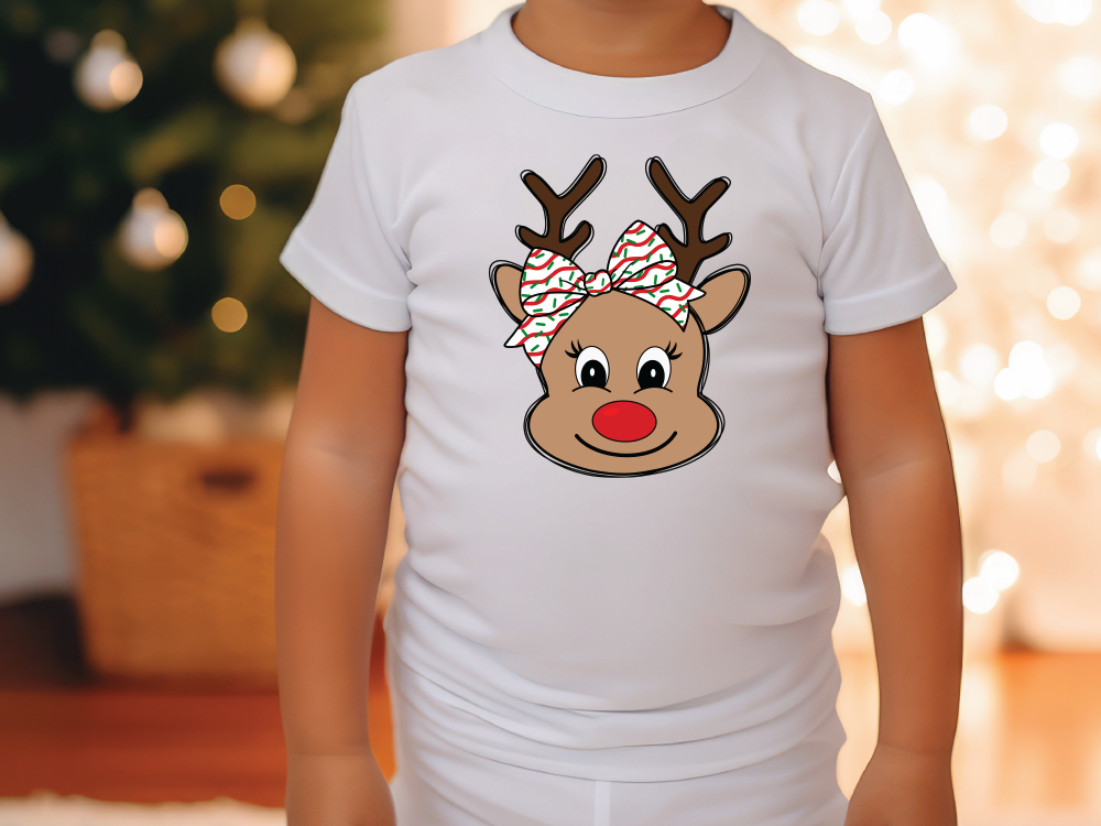 a young child wearing a white shirt with a reindeer head on it