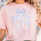 A woman wearing a pink t-shirt with the text "WILD GATS" printed on it.