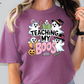 a woman wearing a purple teaching my boos t - shirt