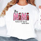 a woman wearing a white shirt with the word mom on it