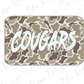 A camouflage-patterned rectangular object with the word "COUGARS" written in bold white letters on it.