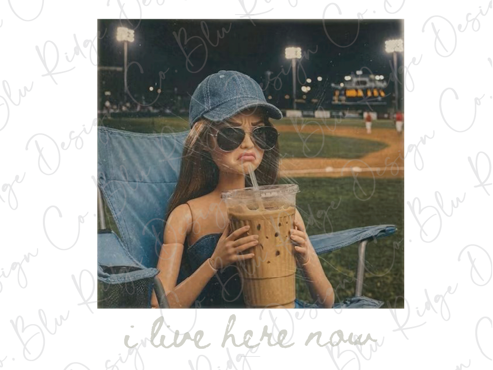 A doll wearing a blue cap and sunglasses is sitting in a chair, holding a large drink in a plastic cup.