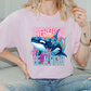 a woman sitting on a couch wearing a pink shirt