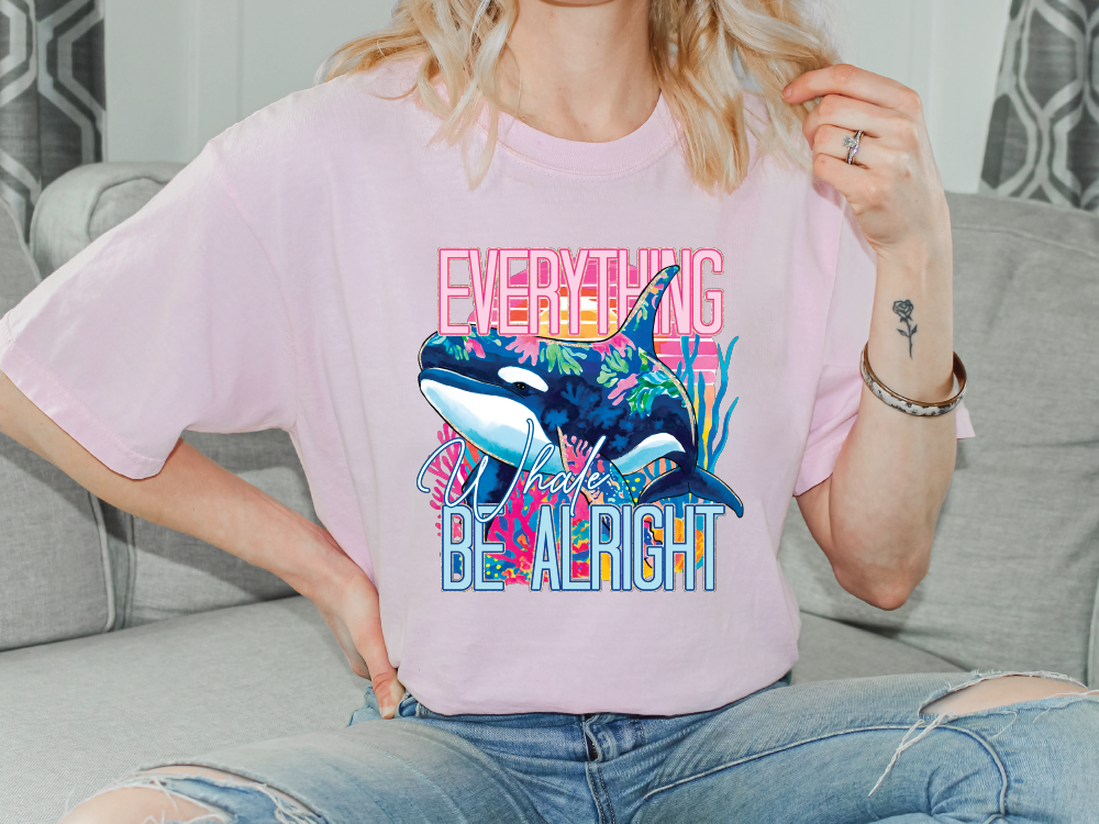 a woman sitting on a couch wearing a pink shirt