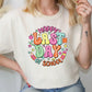 a woman sitting on a chair wearing a happy birthday t - shirt