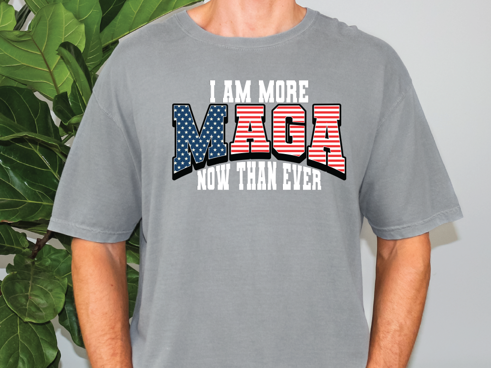 a man wearing a gray shirt that says i am more maga now than ever