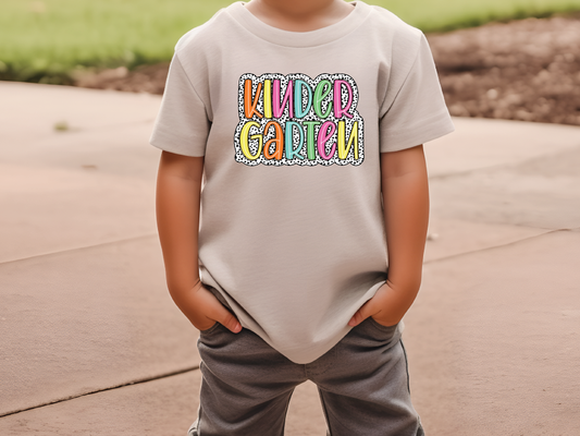 a young boy wearing a t - shirt that says kind of garden