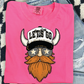 A pink t-shirt with a graphic design of a bearded Viking wearing sunglasses and a hat with the text "LET'S GO" printed on it.