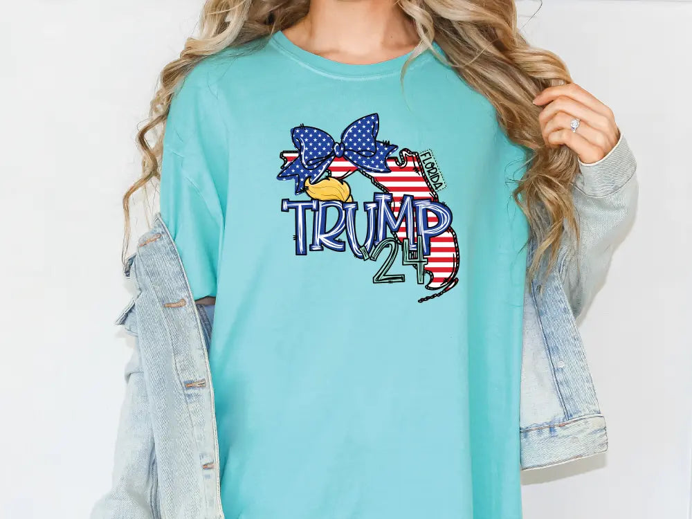 a woman wearing a blue shirt with the word trump printed on it