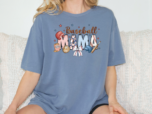 a woman sitting on a couch wearing a baseball mom shirt