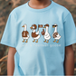 A light blue t-shirt with a graphic design of four cartoon ducks in different poses, including one holding a football and wearing a hat.
